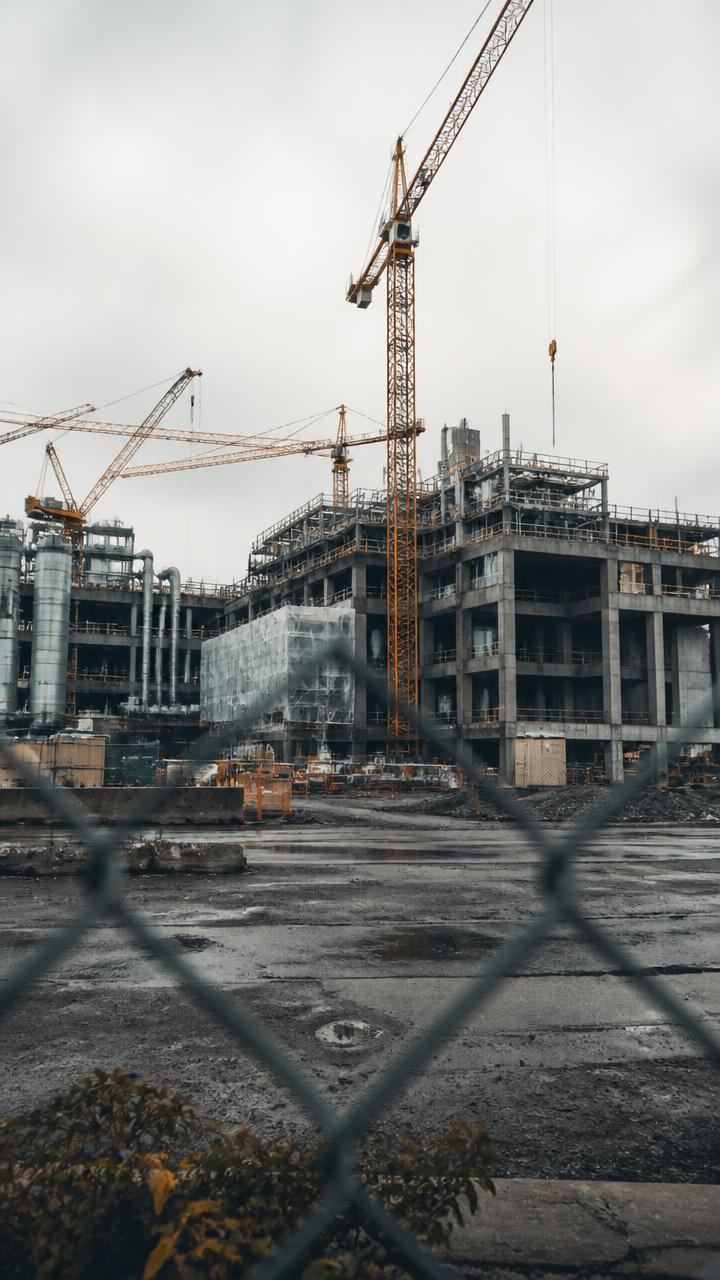 Industrial campus under construction behind a chain link fence in Everett